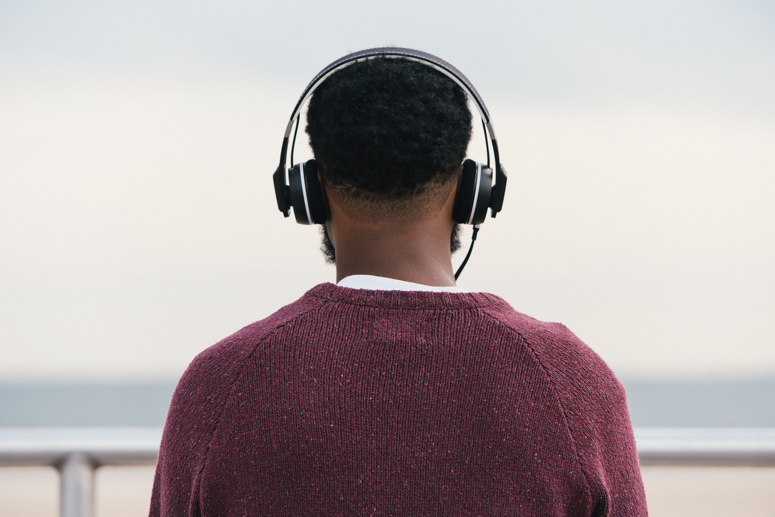 man listening to music via headphones